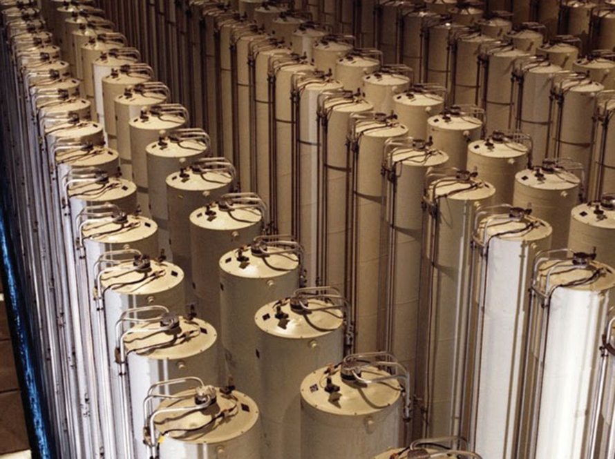 Hundreds of tall cylinders arranged pair-wise in rows, photographed from an elevated vantage point