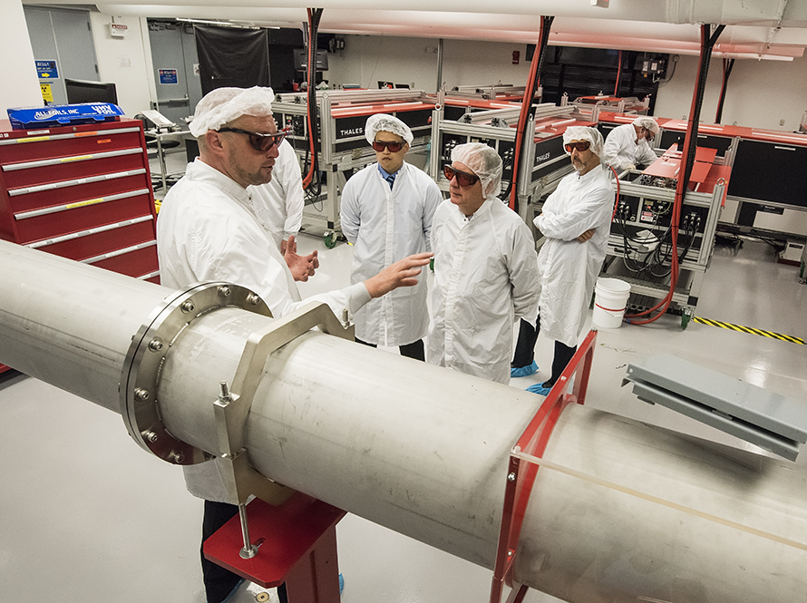 Scientists in white coats and protective glasses touring Berkeley Lab